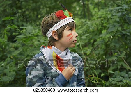 Boy dressed up in face paint and playing in forest View Large Photo Image Stock Photo - Boy dressed up in face paint and playing in forest. Fotosearch