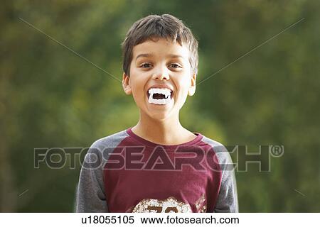 Boy wearing fake vampire teeth with fangs View Large Photo Image Stock Photography - Boy wearing fake vampire teeth with fangs. Fotosearch