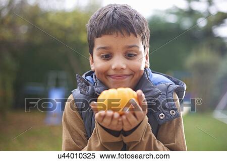 Boy with pumpkin posing in garden View Large Photo Image Stock Photography - Boy with pumpkin posing in garden. Fotosearch