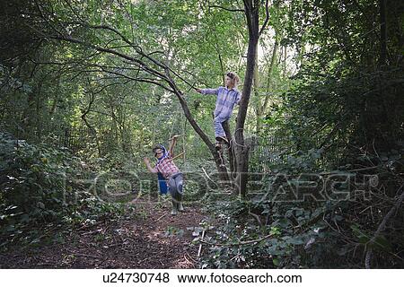 Stock Photo - Boys dressed in cape playing in forest. Fotosearch