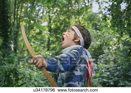 Boys playing in forest with bow and arrow View Large Photo Image Stock Photograph - Boys playing in forest with bow and arrow. Fotosearch