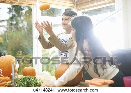 Brother and sister with homegrown pumpkins in kitchen View Large Photo Image Stock Image - Brother and sister with homegrown pumpkins in kitchen. Fotosearch