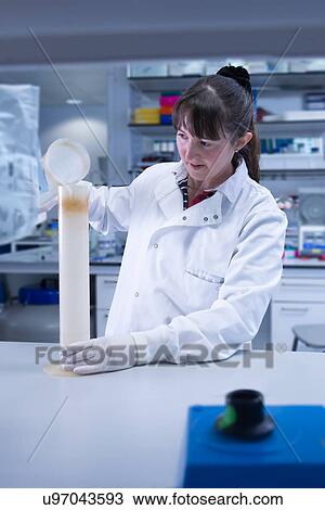 Stock Image - "Cancer research laboratory, female scientist at work". Fotosearch