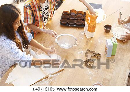 Stock Photography - Children making dough in kitchen. Fotosearch