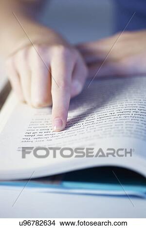 Close up of girls finger pointing on reading book View Large Photo Image Picture - Close up of girls finger pointing on reading book. Fotosearch