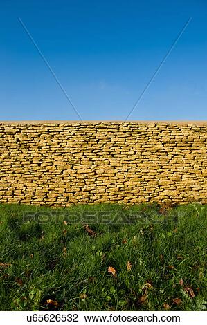 Cotswold Stone wall against blue sky View Large Photo Image Stock Image - Cotswold Stone wall against blue sky. Fotosearch