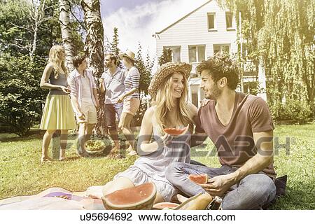 Couple eating watermelon in garden View Large Photo Image Stock Image - Couple eating watermelon in garden. Fotosearch