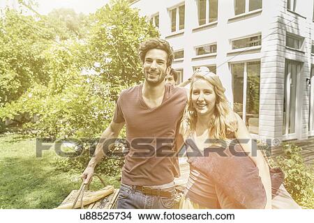Picture - Couple preparing for picnic in garden. Fotosearch
