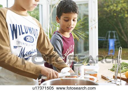 Cropped shot of boys opening tin of tomato soup View Large Photo Image Stock Photography - Cropped shot of boys opening tin of tomato soup. Fotosearch
