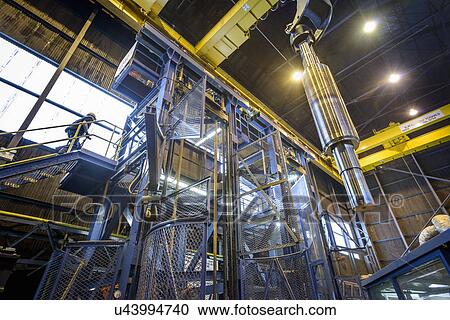 "Engineer heat treating steel parts in engineering factory, low angle view" View Large Photo Image Stock Image - "Engineer heat treating steel parts in engineering factory, low angle view". Fotosearch