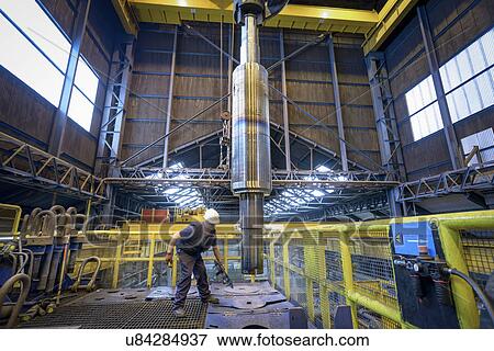 Engineer heat treating steel parts in engineering factory View Large Photo Image Stock Photo - Engineer heat treating steel parts in engineering factory. Fotosearch