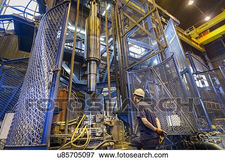 Engineer heat treating steel parts in induction furnace in engineering factory View Large Photo Image Stock Photo - Engineer heat treating steel parts in induction furnace in engineering factory. Fotosearch