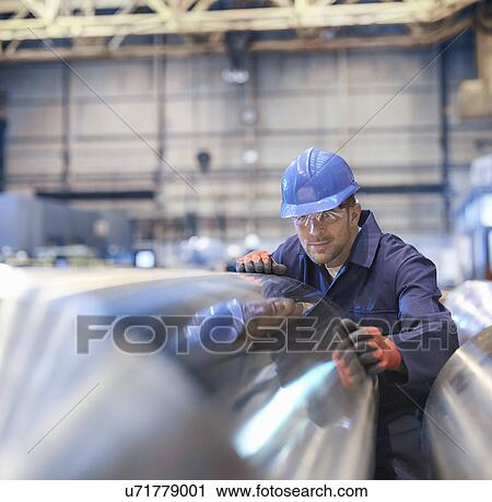 Engineer inspecting finished steel roller in engineering factory View Large Photo Image Stock Image - Engineer inspecting finished steel roller in engineering factory. Fotosearch