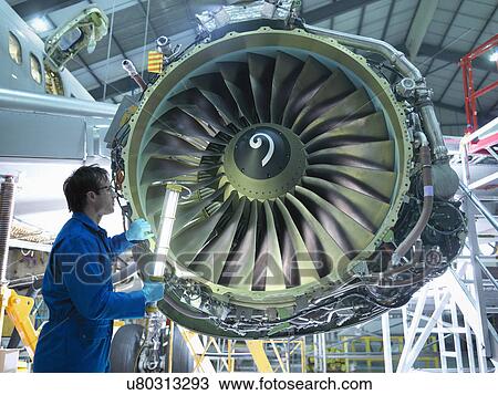 Engineer inspecting jet engine in aircraft maintenance factory View Large Photo Image Stock Image - Engineer inspecting jet engine in aircraft maintenance factory. Fotosearch