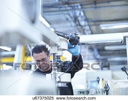 Engineer operating honing machine in factory View Large Photo Image Stock Photography - Engineer operating honing machine in factory. Fotosearch
