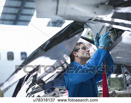 "Engineer working on aircraft wing in aircraft maintenance factory, close up" View Large Photo Image Stock Photo - "Engineer working on aircraft wing in aircraft maintenance factory, close up". Fotosearch