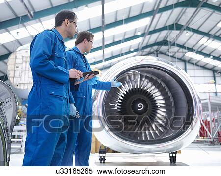 Engineers discussing engine in aircraft maintenance factory View Large Photo Image Stock Photography - Engineers discussing engine in aircraft maintenance factory. Fotosearch