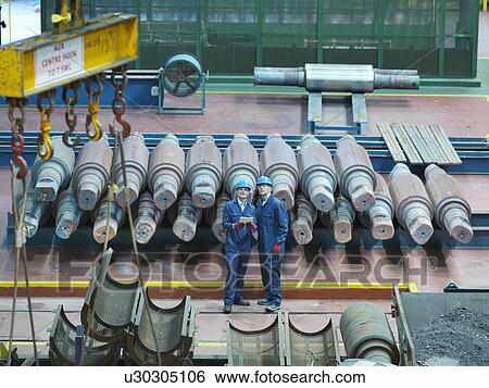"Engineers looking up in engineering factory, high angle view" View Large Photo Image Stock Photograph - "Engineers looking up in engineering factory, high angle view". Fotosearch
