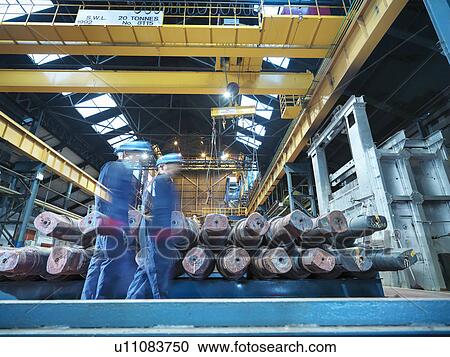 "Engineers on the move in engineering factory, low angle view" View Large Photo Image Stock Image - "Engineers on the move in engineering factory, low angle view". Fotosearch