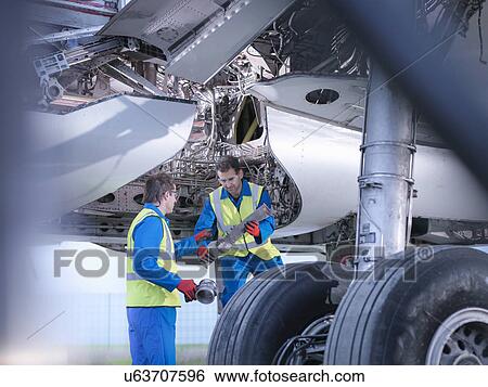 Engineers recycling aircraft parts from airplane on runway View Large Photo Image Stock Photograph - Engineers recycling aircraft parts from airplane on runway. Fotosearch