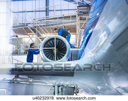 Engineers working on aircraft engine in aircraft maintenance factory View Large Photo Image Stock Photo - Engineers working on aircraft engine in aircraft maintenance factory. Fotosearch