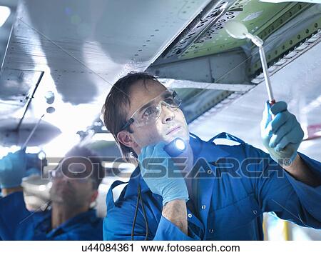 "Engineers working on aircraft wing in aircraft maintenance factory, close up" View Large Photo Image Stock Image - "Engineers working on aircraft wing in aircraft maintenance factory, close up". Fotosearch