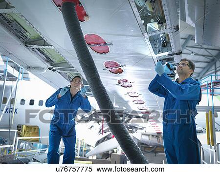 Engineers working on aircraft wing in aircraft maintenance factory View Large Photo Image Stock Photography - Engineers working on aircraft wing in aircraft maintenance factory. Fotosearch