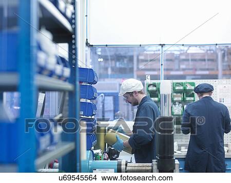 Picture - Engineers working together in clean room of factory. Fotosearch