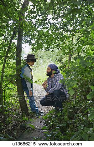 Father advising son in forest View Large Photo Image Stock Photography - Father advising son in forest. Fotosearch