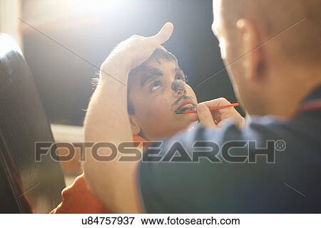 Father painting sons lips for halloween View Large Photo Image Stock Photo - Father painting sons lips for halloween. Fotosearch