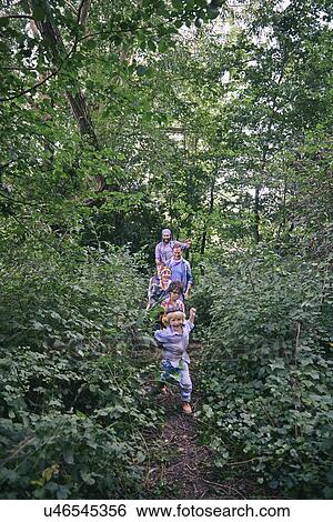 Fathers and sons playing chase in forest View Large Photo Image Stock Photograph - Fathers and sons playing chase in forest. Fotosearch