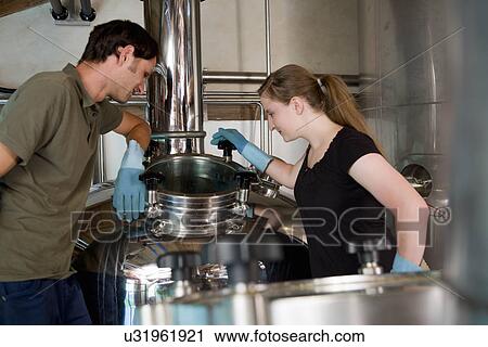 Female brewer working in brewhouse View Large Photo Image Stock Image - Female brewer working in brewhouse. Fotosearch