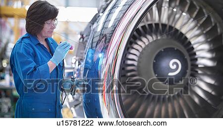 Female engineer working on engine in aircraft maintenance factory View Large Photo Image Stock Image - Female engineer working on engine in aircraft maintenance factory. Fotosearch