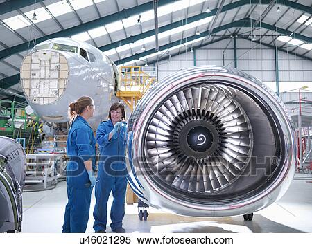 Female engineers working on engine in aircraft maintenance factory View Large Photo Image Stock Photography - Female engineers working on engine in aircraft maintenance factory. Fotosearch