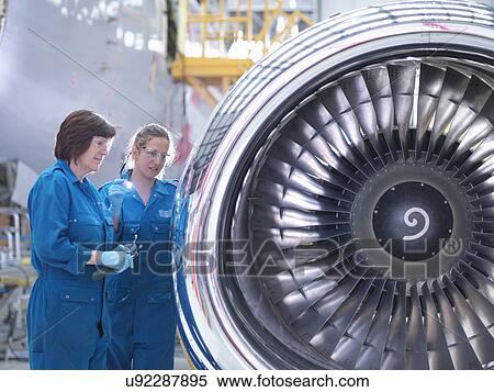 Female engineers working on engine in aircraft maintenance factory View Large Photo Image Stock Photography - Female engineers working on engine in aircraft maintenance factory. Fotosearch
