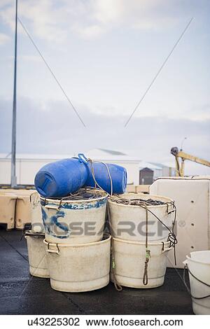 Stock Image - Fishing lines and buoys on boat deck. Fotosearch