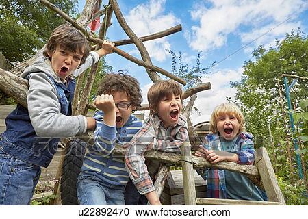 Four boy shouting on homemade climbing frame in garden View Large Photo Image Stock Image - Four boy shouting on homemade climbing frame in garden. Fotosearch