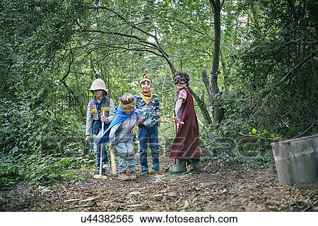 Four boys dressed up and playing in forest View Large Photo Image Stock Photography - Four boys dressed up and playing in forest. Fotosearch