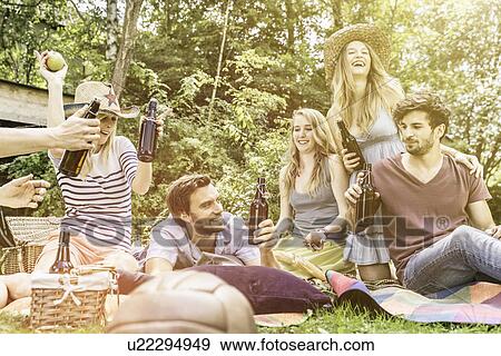 Friends drinking beer in garden View Large Photo Image Stock Photo - Friends drinking beer in garden. Fotosearch