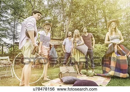 Friends having picnic in garden View Large Photo Image Stock Photograph - Friends having picnic in garden. Fotosearch