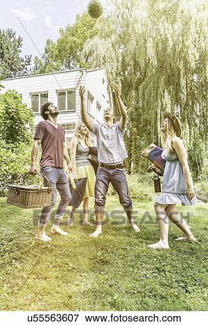 Friends playing catch with watermelon in garden View Large Photo Image Stock Photo - Friends playing catch with watermelon in garden. Fotosearch