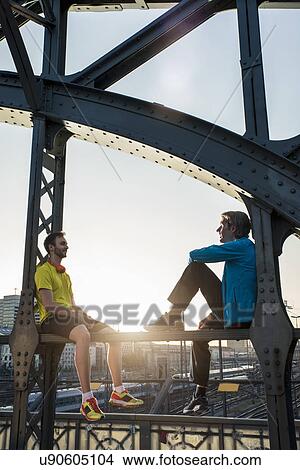 Picture - "Friends relaxing on bridge, Munich, Bavaria, Germany". Fotosearch