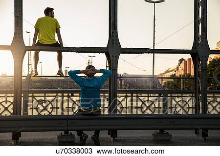 "Friends relaxing on bridge, Munich, Bavaria, Germany" View Large Photo Image Stock Image - "Friends relaxing on bridge, Munich, Bavaria, Germany". Fotosearch
