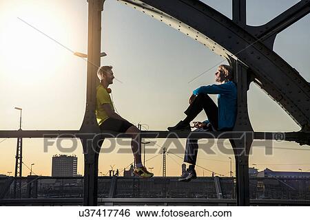 "Friends relaxing on bridge, Munich, Bavaria, Germany" View Large Photo Image Stock Photograph - "Friends relaxing on bridge, Munich, Bavaria, Germany". Fotosearch
