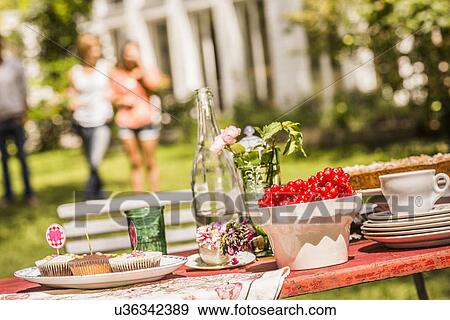 "Garden party food table, group of friends in background" View Large Photo Image Stock Photo - "Garden party food table, group of friends in background". Fotosearch