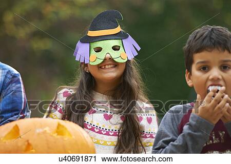 Girl wearing mask over head View Large Photo Image Stock Image - Girl wearing mask over head. Fotosearch