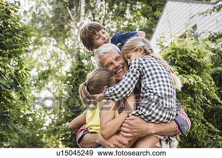 Grandfather holding three grandchildren View Large Photo Image Stock Photo - Grandfather holding three grandchildren. Fotosearch