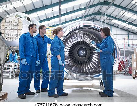 Group of engineers working on engine in aircraft maintenance factory View Large Photo Image Stock Photograph - Group of engineers working on engine in aircraft maintenance factory. Fotosearch