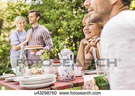 Group of friends at garden party View Large Photo Image Stock Image - Group of friends at garden party. Fotosearch