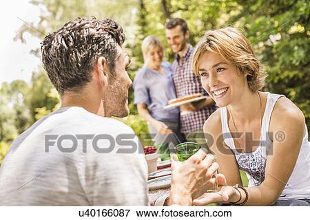 Stock Photo - Group of friends at garden party. Fotosearch